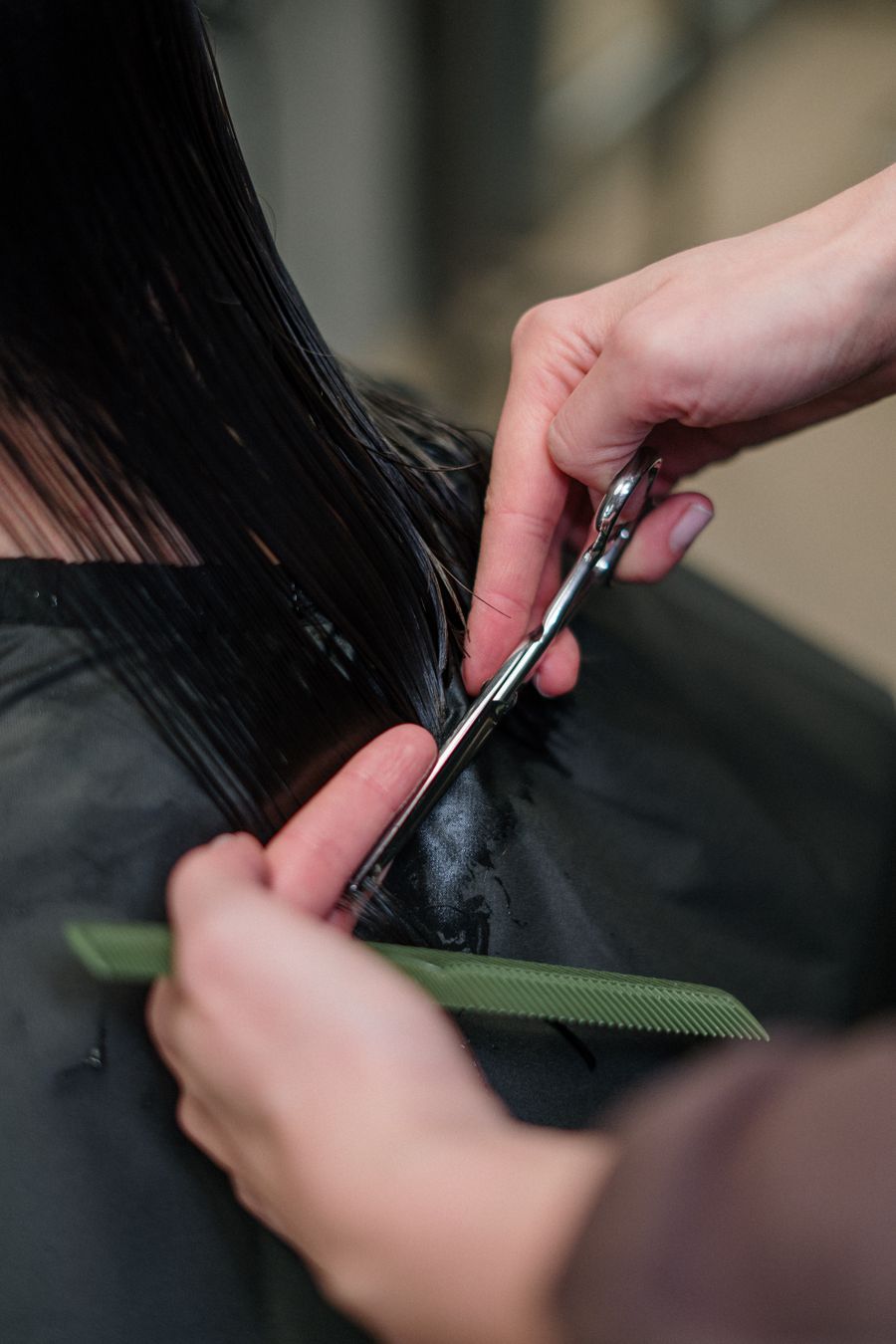 Stylist giving a precision haircut to a client