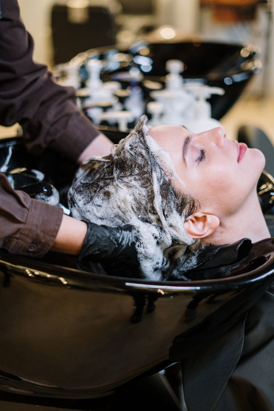 Hair spa treatment being applied to client's hair at the salon