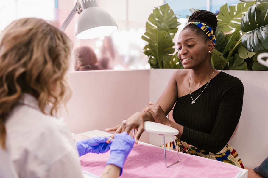 Woman having a manicure at the nail station